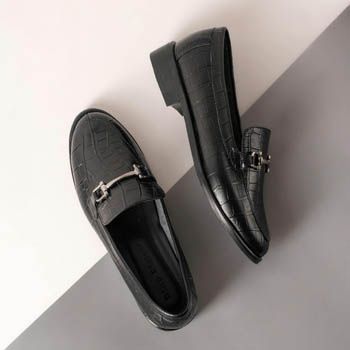 Black leather loafers with a metal bit